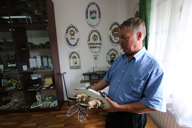 Laszlo Merkli v Števanovskem muzeju madžarske mejne straže kaže hodulje z jelenjimi nogami, s kakršnimi so hoteli prebežniki pretentati stražo. FOTO: Jože Pojbič/Delo