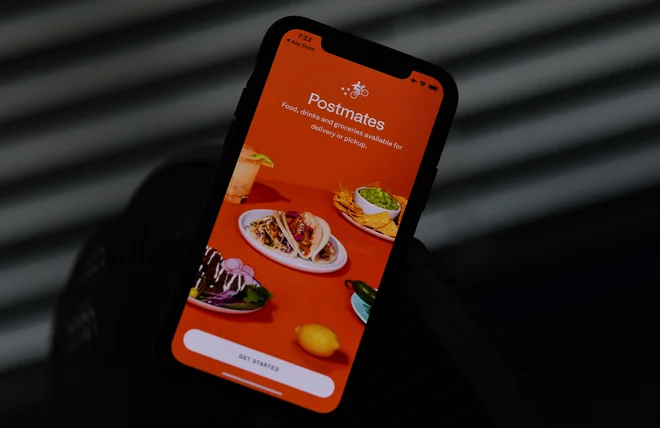 Uber bo za Postmates plačal 2,65 milijarde dolarjev. FOTO: Chris Delmas/AFP