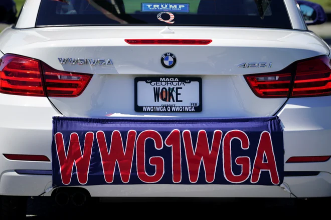 »Where we go one, we go all«, kamor gre eden, gremo vsi oziroma okrajšava #WWG1WGA je eden od prepoznavnih sloganov gibanja ali bolje: kar kulta. Foto Elijah Nouvelage/Reuters