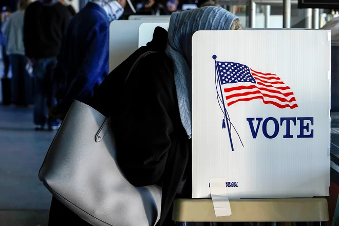 FILE PHOTO: A voter fills out her ballot during early voting at ONEOK Field in Tulsa, Oklahoma, U.S., October 30, 2020. REUTERS/Nick Oxford/File Photo