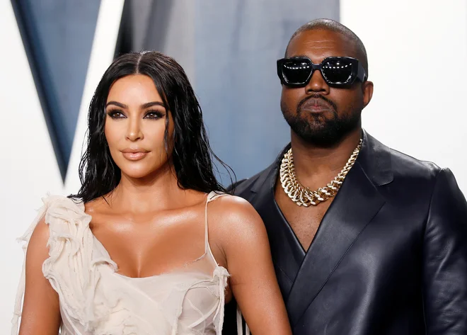 Kim Kardashian in Kanye West v Los Angelesu februarja lani. FOTO: Danny Moloshok/Reuters