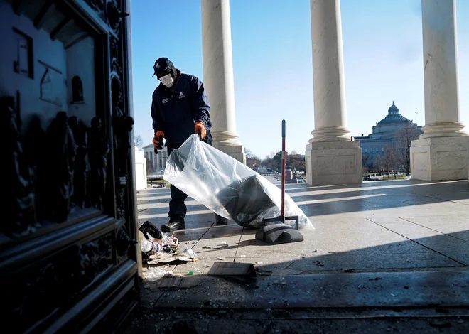 A worker cleans up debris outside the U.S. Capitol a day after supporters of U.S. President Donald Trump stormed the Capitol in Washington, U.S., January 7, 2021. REUTERS/Erin Scott