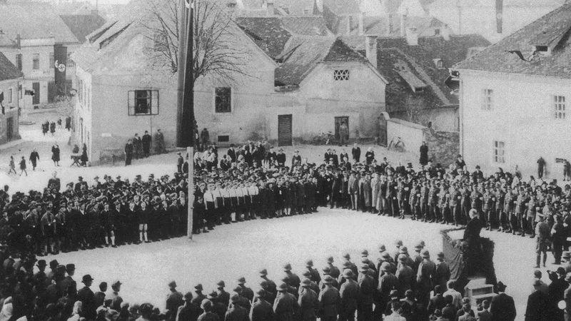 Fotografija: Govornik na Aškerčevem trgu (takrat Trg Adolfa Hitlerja) najverjetneje leta 1942 naj bi bil okrožni vodja Anton Dorfmeister, na oknu Bastove hiše pa je stala Pauline. FOTO: osebni arhiv Martina Pollacka