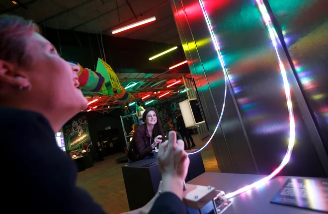 Staff of the V & A interact with items on display at Videogames: Design/Play/Disrupt, which celebrates the changing design field of video games, in London, Britain September 5, 2018. REUTERS/Peter Nicholls - RC1B640E5780