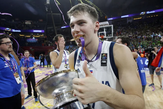 Ko je Luka Dončić zadnjič doslej nosil dres slovenske reprezentance, je v imel v rokah šampionski pokal in med zobmi zlato kolajno z EP. FOTO: Samec Blaž/Delo