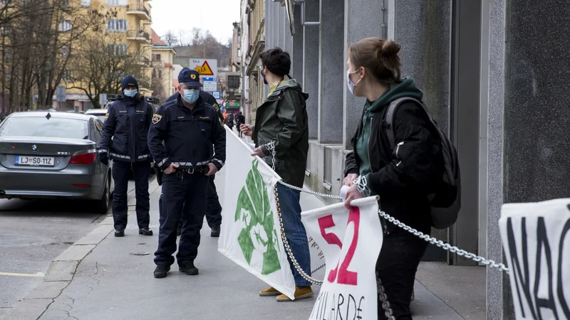 Fotografija: Mladi za podnebno pravičnost so se zaradi vladnega predloga načrta za okrevanje priklenili pred vladno poslopje. FOTO: Nejc Trampuž