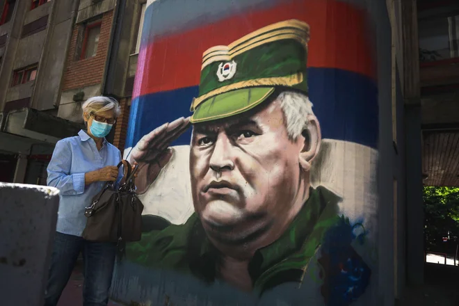 Vojaški poveljnik Srbov v Bosni in Hercegovini Ratko Mladić, ki je obsojen na dosmrtno zaporno kazen zaradi vojnih zločinov in genocida, je v Srbiji in delih srbskih BiH pogosta tema uličnih slikarij, njegova podoba pa krasi navijaške rekvizite. Tudi po današnji razsodbi v Haagu bo pot do sprave še dolga. FOTO: Andrej Isakovic/AFP