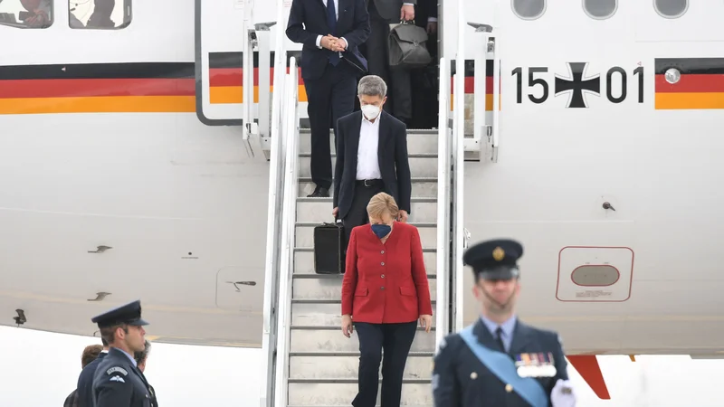 Fotografija: Nemška kanclerka Angela Merkel in njen mož Joachim Sauer ob prihodu na letališče v britanskem Cornwallu, kjer poteka zasedanje skupine G7. FOTO: Stefan Rousseau/AFP