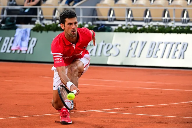 Novak Đoković med polfinalnim obračunom z Rafaelom Nadalom. FOTO: Martin Bureau/AFP