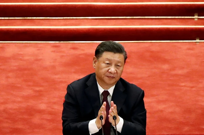 FILE PHOTO: Chinese President Xi Jinping applauds during a meeting to commend role models in China's fight against the coronavirus disease (COVID-19) outbreak, at the Great Hall of the People in Beijing, China September 8, 2020. REUTERS/Carlos Garcia Rawlins/File Photo    To match Special Report HONGKONG-TAIWAN/MILITARY