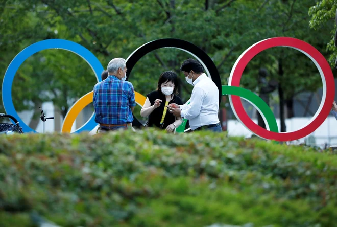 Mnogi so protestirali, toda olimpijski krogi bodo julija vnovič oživeli. FOTO: Issei Kato/Reuters