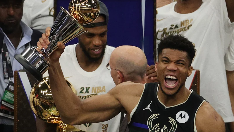 Fotografija: Giannis Antetokounmpo v šampionskem vrvežu po odločilni zmagi košarkarjev Milwaukeeja nad Phoenixom. FOTO: Jonathan Daniel/AFP