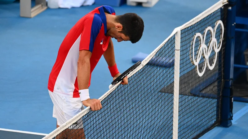 Fotografija: Novak Đoković (na fotografiji) med obračunom za bronasto odličje v Tokiu. FOTO: Vincenzo Pinto/AFP