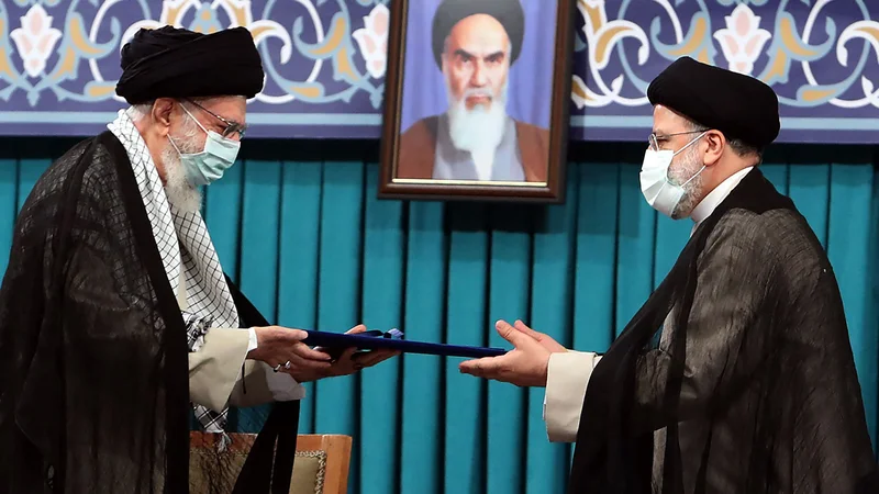 Fotografija: Vrhovni iranski verski voditelj ajatola Ali Hamenej (levo) in novi iranski predsednik Ebrahim Raisi med današnjo slovesnostjo v Teheranu. Foto: Afp