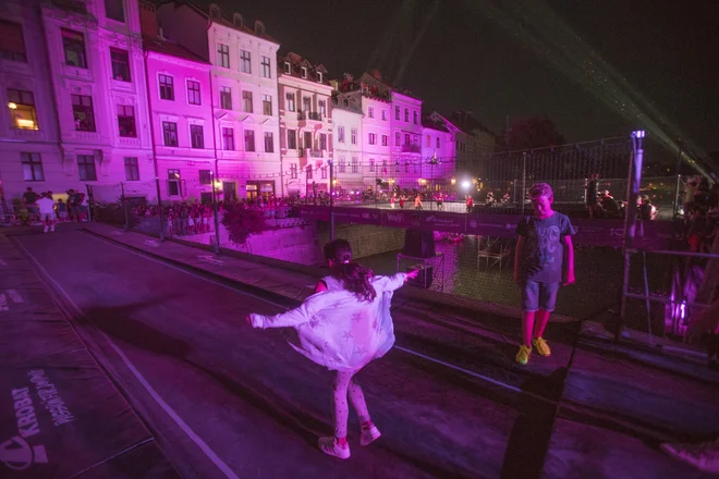 Tokrat je bregova Ljubljanice povezoval še trampolinski most. Čezenj je kajpak najbolj razposajeno skakala mladež. FOTO: Jure Eržen/Delo