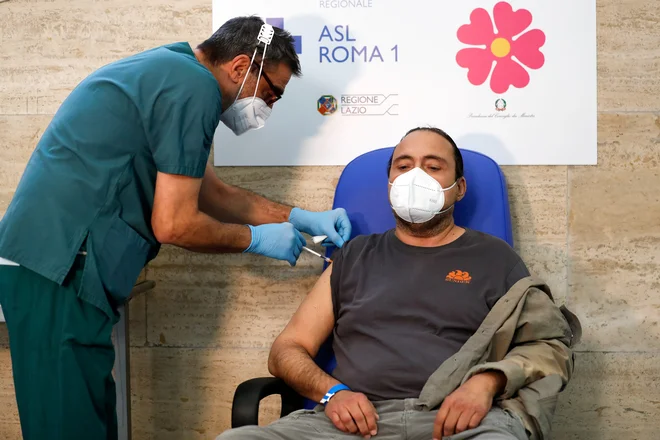 V Italiji naj bi po vladnih predvidevanjih v tednu dni dosegli 80-odstotno precepljenost populacije proti covidu-19 med starejšimi od 12 let. Začeli so tudi s cepljenjem ranljivih skupin s tretjim odmerkom. FOTO: REUTERS/Yara Nardi