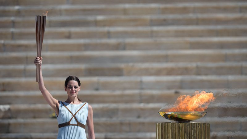Fotografija: Grška igralka Xanthi Georgiou, oblečena v antično grško svečenico, drži olimpijsko baklo na marčevski slovesnosti pred poletnimi OI v Tokiu. FOTO: Aris Messinis/AFP
