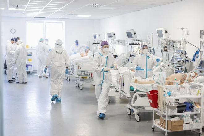 Rekordno težke razmere v novi covidni bolnišnici v Novem Sadu obiskovalcu ne dajo občutka, da so le nekaj kilometrov stran v središču mesta lokali in restavracije povsem polni.&nbsp;FOTO: Marko Djurica/Reuters
