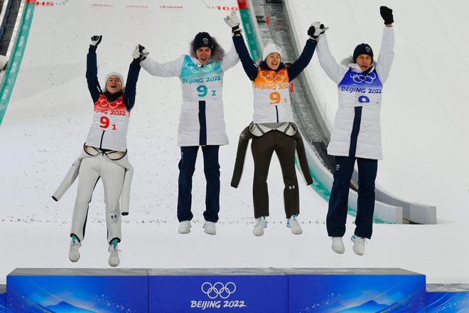 Nika Križnar, Timi Zajc, Urša Bogataj in Peter Prevc so se veselili zlate kolajne v Pekingu. FOTO: Odd Andersen/AFP
