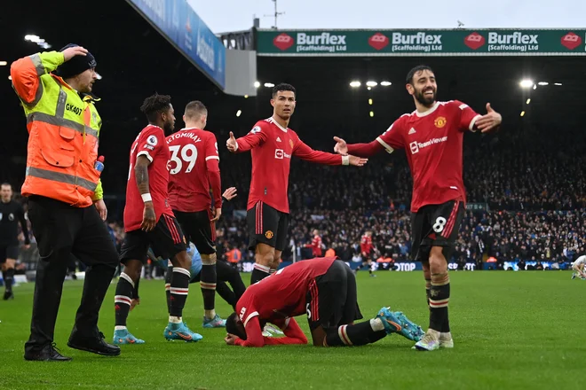 Takole sta opazovala Aarona Wan-Bissako (na tleh) najboljša nogometaša Manchester Uniteda, rojaka Cristiano Ronaldo in Bruno Fernandes. FOTO: Paul Ellis/AFP
