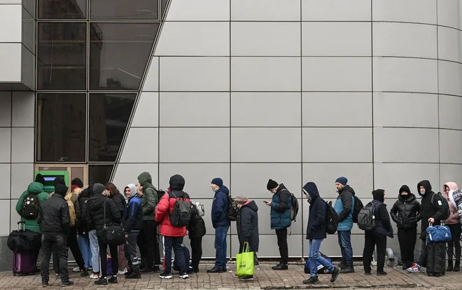 Ljudje v Kijevu v jutranjih urah stojijo v vrsti pred bankomatom. FOTO: Daniel Leal/AFP
