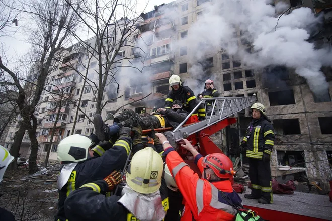 Reševanje iz uničenega objekta v četrti Oblon na severu&nbsp;Kijeva. FOTO: Reševalna služba Ukrajine/AFP&nbsp;
