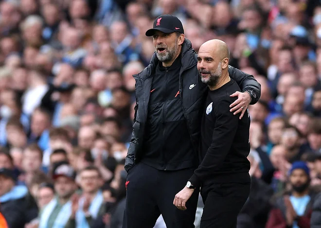 Trenerja Jürgen Klopp in Pep Guardiola FOTO: Phil Noble/Reuters
