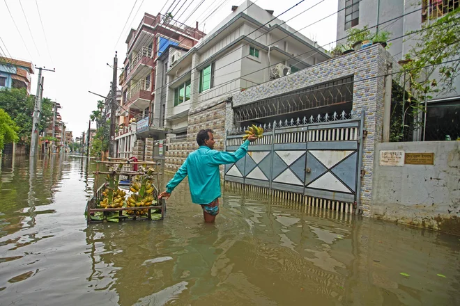 Poplave so v obeh državah relativno pogoste, a v zadnjih letih spričo globalnega segrevanja postajajo vse hujše in pogostejše. FOTO: Mamun Hossain/AFP
