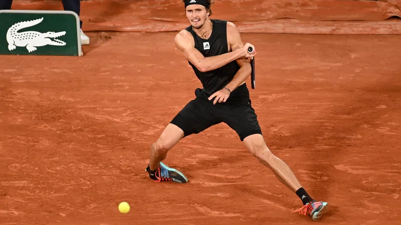 Fotografija: Alexander Zverev se je tri ure odlično upiral Rafaelu Nadalu v polfinalu Roland Garrosa. V 12. igri drugega niza si je zvil gleženj in v velikih bolečinah zapustil igrišče na vozičku. Vrnil se je na berglah in predal obračun. Nadala čaka Casper Ruud. Foto: Tomas Stevens /Afp