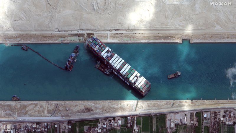Fotografija: Satelitski posnetek zamašene transportne arterije v Sueškem prekopu marca letos. FOTO: Maxar Technologies/Reuters

