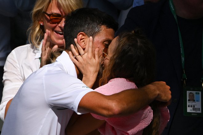 Novak Đoković je po zmagi v finalu proti Nicku Kyrgiosu poljubi ženo Jeleno Đoković. FOTO: Sebastien Bozon/AFP
