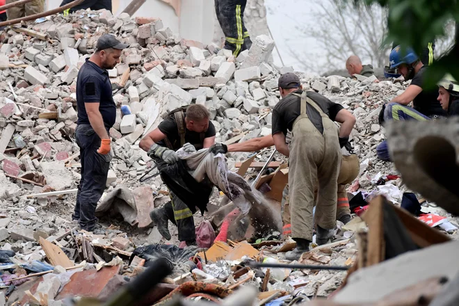 Število smrtnih žrtev po nedeljskem zrušenju petnadstropne stavbe v kraju Časiv Jar na vzhodu Ukrajine, do katerega je prišlo zaradi ruskega obstreljevanja, je danes naraslo na 48. FOTO: Miguel Medina/AFP
