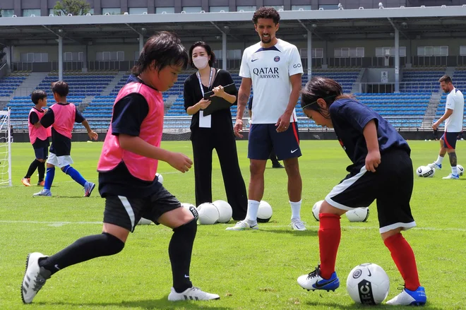 Marquinhos (zgoraj) med spremljanjem treninga najmlajših. FOTO: Toshifumi Kitamura/AFP
