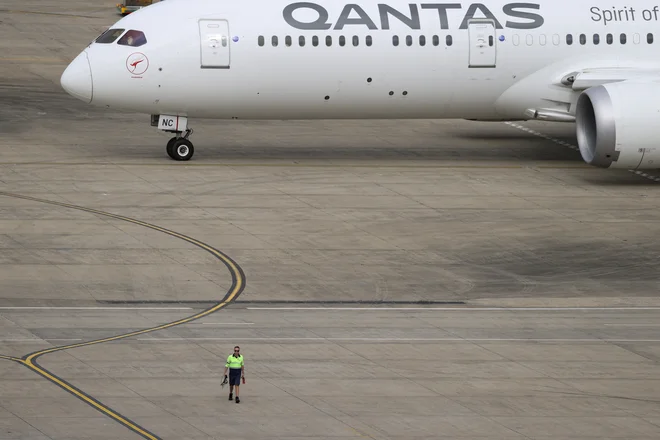 Avstralska letalska družba Qantas je zaprosila svoje uslužbence, naj pomagajo rešiti akutno stisko zaradi pomanjkanja delavcev, ki skrbijo za prtljago. FOTO: Loren Elliott/ Reuters
