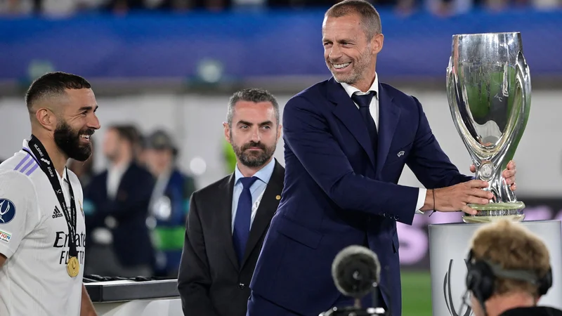 Fotografija: Karim Benzema je takole prejel pokal iz rok Aleksandra Čeferina. FOTO: Javier Soriano/AFP