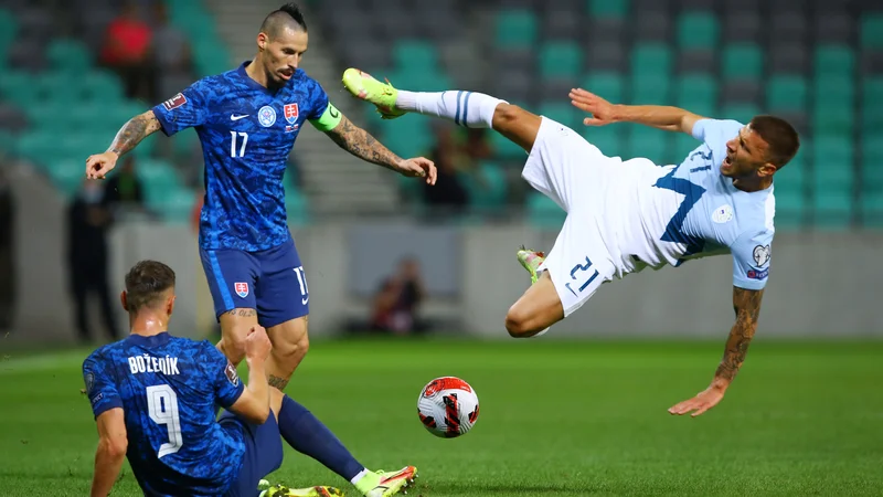Fotografija: Jan Mlakar (desno) med kvalifikacijskim obračunom za nastop na SP 2022 proti Slovaški v Ljubljani. FOTO: Borut Živulović/Reuters