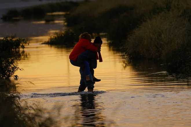 Migranti, ki iščejo azil, iz Ciudad Juareza v Mehiki prečkajo reko Rio Bravo, da bi se predali agentom ameriške mejne patrulje in zaprosili za azil v mestu El Paso v Teksasu. Foto: Jose Luis Gonzalez/Reuters