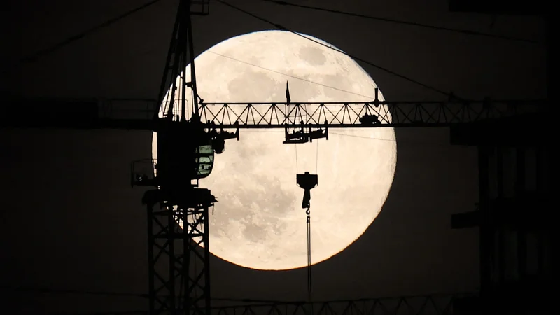 Fotografija: Zadnja polna luna v tem letu, znana kot mrzla luna, vzhaja za gradbiščem v Ankari. Foto: Adem Altan/Afp