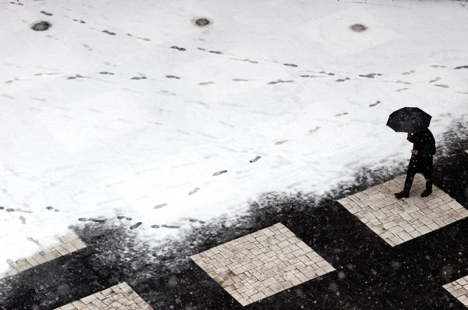 A man walks in the central courtyard of the European Parliament, covered by fresh snow in Strasbourg, France December 14, 2022. REUTERS/Yves Herman TPX IMAGES OF THE DAY
