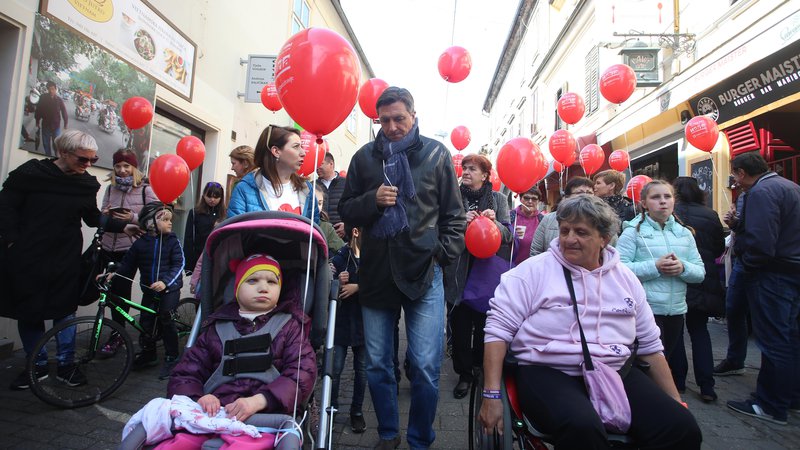 Fotografija: Z rdečimi baloni proti predsodkom o obolelih z redkimi boleznimi. FOTO: Tadej Regent/Delo
