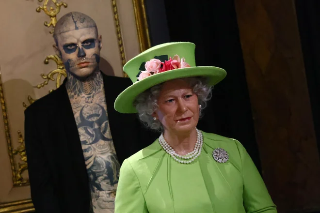 Voščeni kip britanske kraljice Elizabete II. se nahaja poleg voščenega kipa Ricka Genesta, znanega kot Zombie Boy, med odkritjem voščenega kipa britanskega kralja Karla III. v muzeju voščenih lutk Grevin v Parizu. Foto: Yves Herman/Reuters