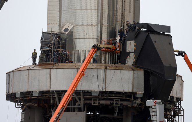 Delavci med pripravami rakete na izstrelitev FOTO: Joe Skipper/Reuters