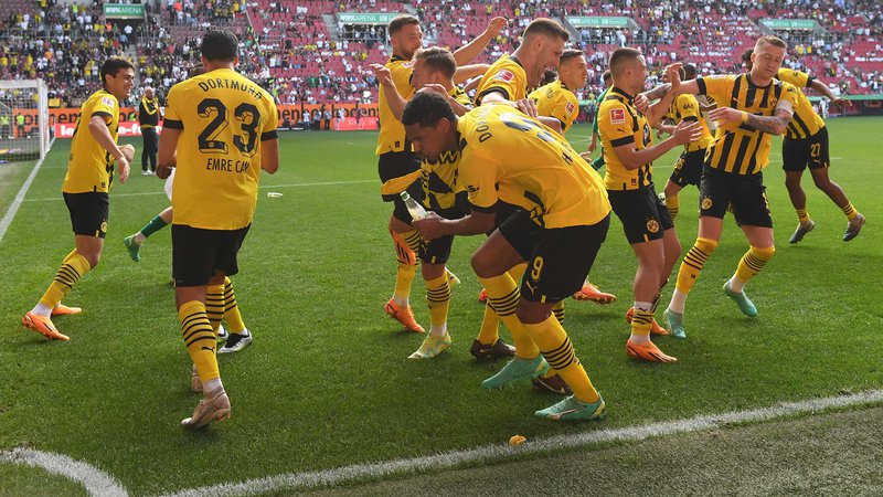 Fotografija: Nogometaši dortmundske Borussie so se takole veselili zmage v Augsburgu. FOTO: Christof Stache/AFP