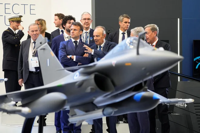 Francoski predsednik Emmanuel Macron v pogovoru z Ericom Trappierom, šefom družbe Dassault Aviation, na mednarodni letalski razstavi na pariškem letališču Le Bourget. FOTO: Michel Euler/Pool/Reuters