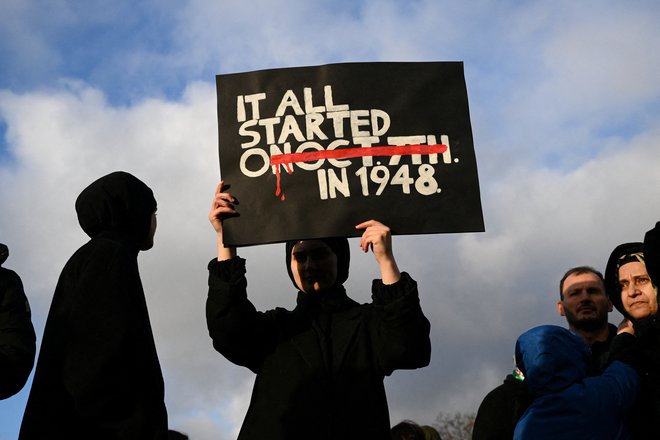 Protestnica v Berlinu s plakatom opozarja, da se nasilje nad Palestinci ni začelo po Hamasovem pokolu 7. oktobra, ampak z nakbo leta 1948. FOTO: Annegret Hilse/Reuters