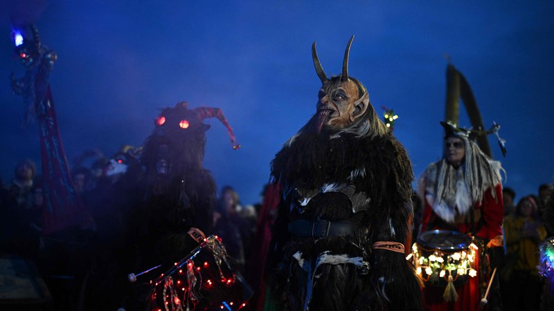 Fotografija: Udeleženci, oblečeni v Krampusa, pol kozla, pol demona, ki kaznuje ljudi, ki se v božičnem času grdo obnašajo, so se udeležili teka »The Whitby Krampus Run« v mestu Whitby na severovzhodu Anglije. Foto: Oli Scarff/Afp