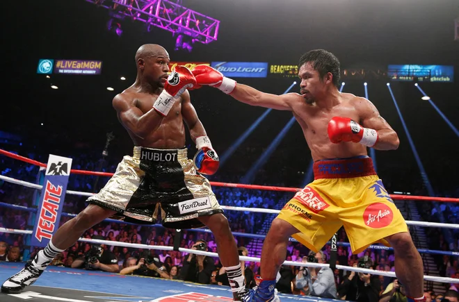 Dvoboj Mayweatherja in Pacquiaa je bil označen za boksarski dvoboj (vsaj) desetletja. FOTO: John Gurzinski/AFP