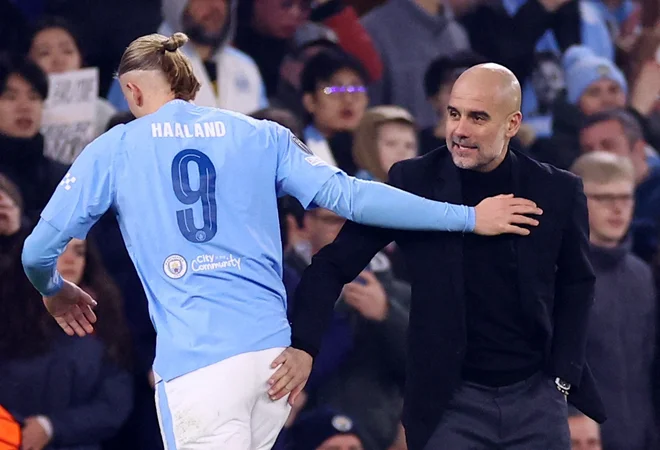 Erling Haaland in Cityjev trener Pep Guardiola sta se veselila napredovanja v četrtfinale lige prvakov. FOTO: Carl Recine/Reuters