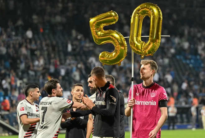 Nogometaši Bayerja iz Leverkusna s finskim vratarjem Lukasom Hradeckym (desno) na čelu že 50 zaporednih tekem niso doživeli poraza. FOTO: Ina Fassbender/AFP