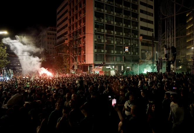 Na Omonia trgu v Atenah so Panathinaikosovi navijači bučno proslavili naslov evropskega prvaka. FOTO: Louisa Gouliamaki/Reuters